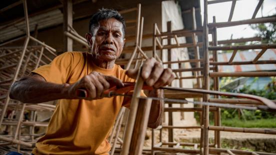 Artisan crafting rattan handicrafts in Lelekaa Village, South Konawe, Indonesia..